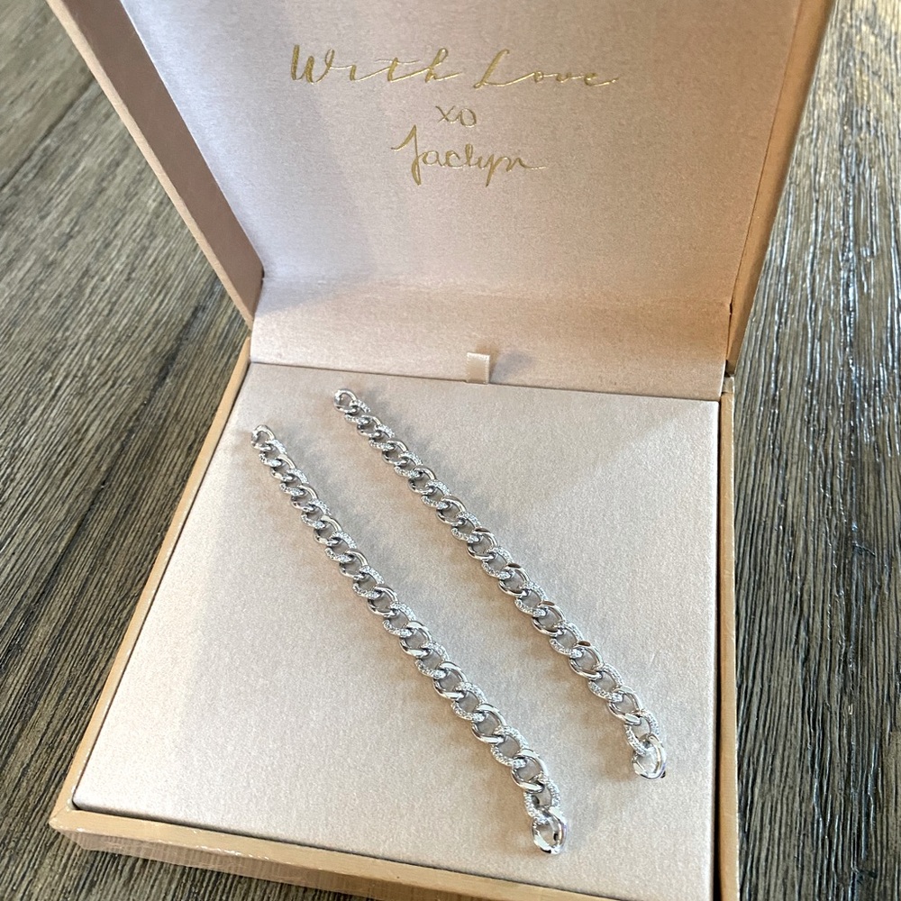 Jaclyn Roxanne drop chain earrings in rhodium.
